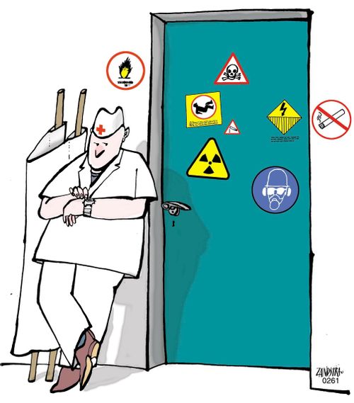 Paramedic waiting outside a door with hazard signs.