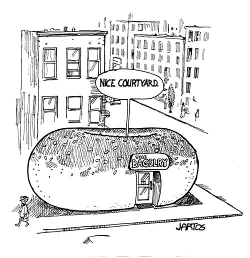 Customer admires courtyard of bagel shaped restaurant.