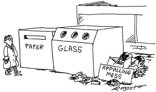 Man at recycling area of supermarket. Signs read 'paper', 'glass' and 'appalling mess'.