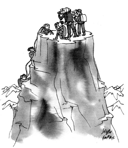 Film crew waits at the top of a mountain to film mountain climbers.