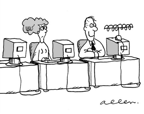 Man in office watching TV instead of a computer monitor.