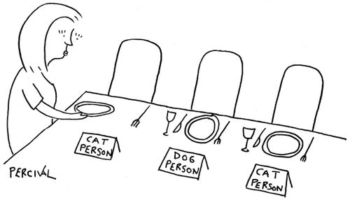 Woman setting out a dinner party with name cards labeled cat person, dog person.