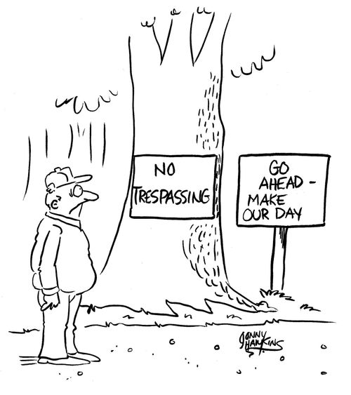 Man in woods sees sign, 'No Trespassing', next to 'Go Ahead - Make Our Day!'