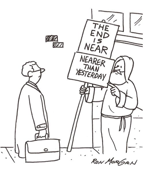 Man holds sign: The End Is Near - Nearer Than Yesterday.