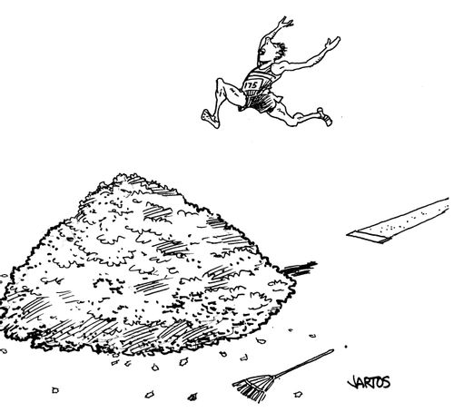 Man does long jump onto pile of leaves.