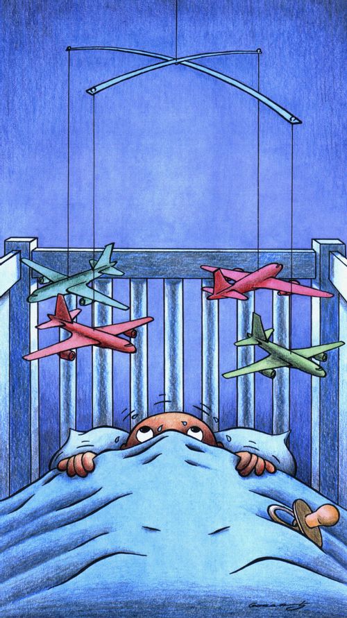 Baby frightened by aircraft mobile.