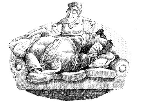 Husband sleeping on the sofa overlooked by wife