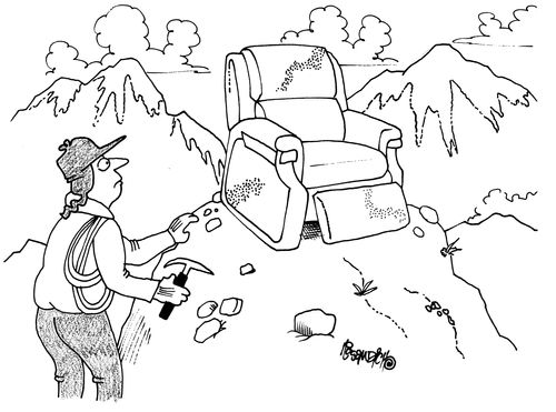Man discovers armchair at mountain top.