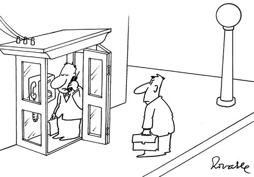 Man in a phone booth using a mobile phone.