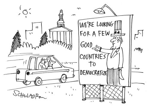 Sign in the US - 'We're looking for a few good countries to democratize'.