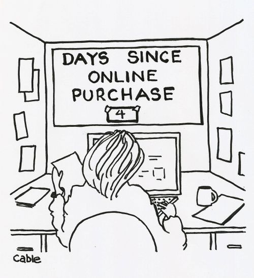Employee in cubicle with sign in front of computer 'Days since online purchase.'