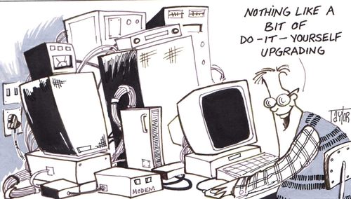 Computer nerd sits at do-it-yourself upgraded computer.