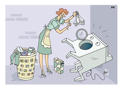 Housewife feeding her washing machine with a brief.