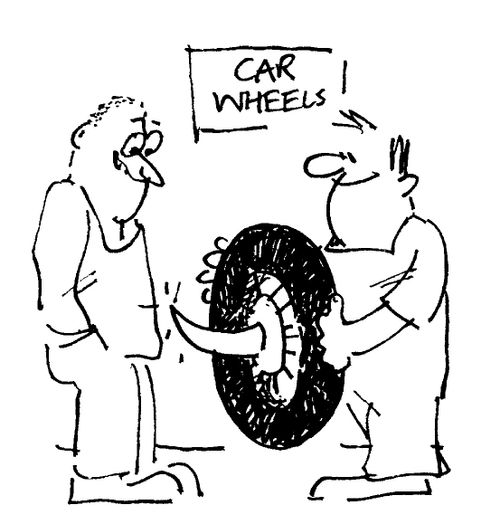 Men smiling over a spiked tyre