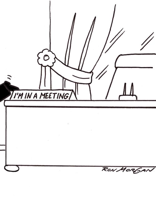 Business executive has desk sign stating: I am in a meeting.
