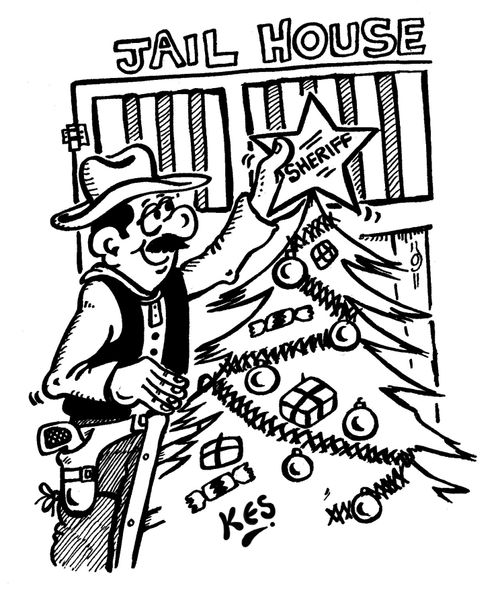 Sheriff places his star on top of a Christmas tree.