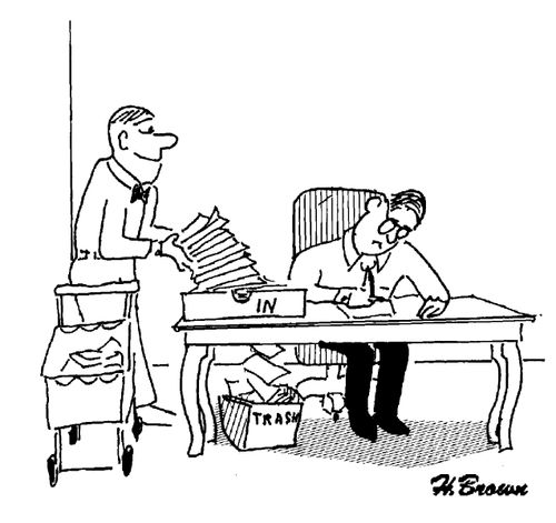 Man has his in tray pour his papers straight into the bin.