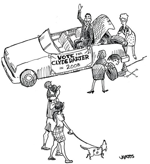 Election candidate having a tyre replaced on his car.