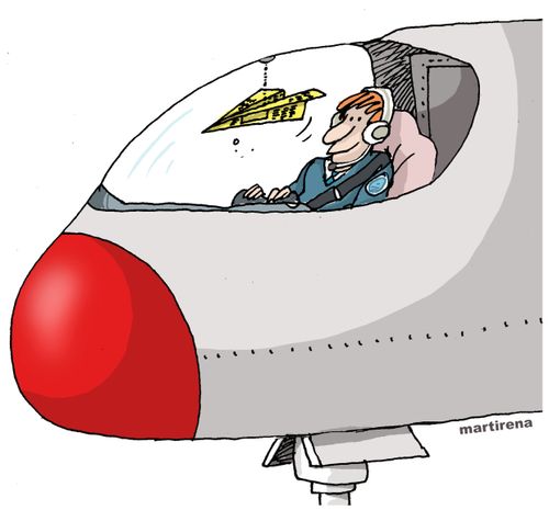 Airplane cockpit has a paper aeroplane in it. 
