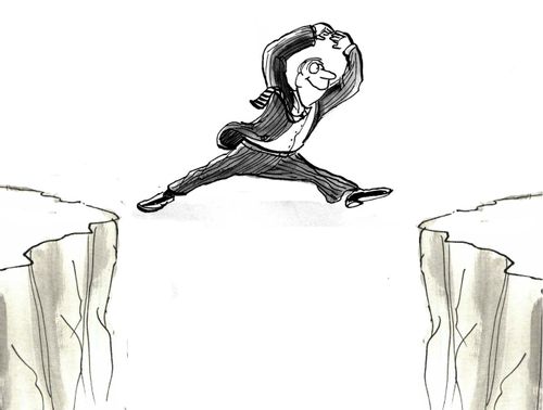 Man is successfully leaping over chasm.