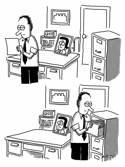 Wife's picture on desk watches her husband work.