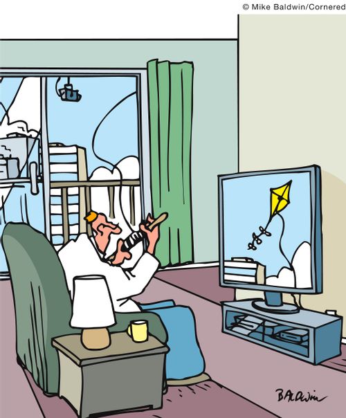 Man watches a kite on television that he is flying from inside.