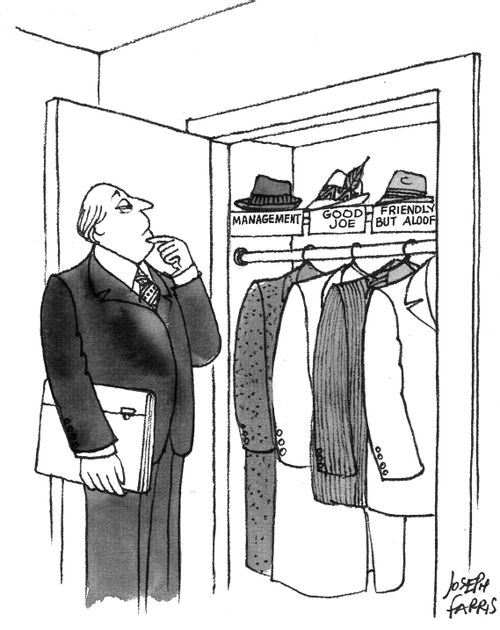 Man deciding which hat to wear