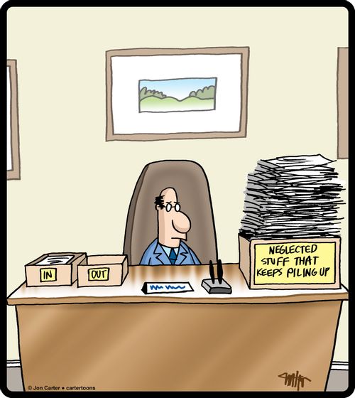 Tray on businessman's desk is for neglected stuff that keeps piling up.