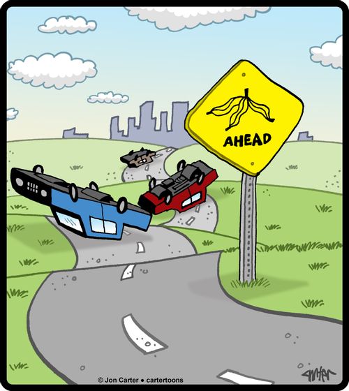 Banana peel warning sign with slipped and wrecked cars.