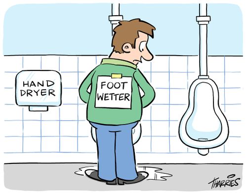 Man with 'foot wetter' sign on back stands near hand dryer