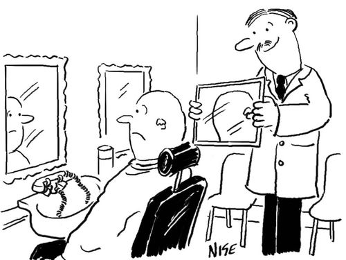 Barber shaves a customer's head.