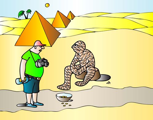 A mummy begs for change in front of the pyramids.