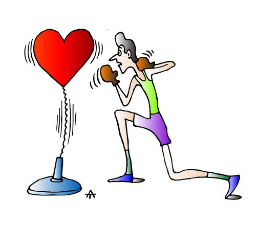 A boxer fights a heart shaped punching bag.