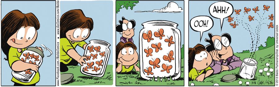 Gracie and Tia Carmen release butterflies from a jar.