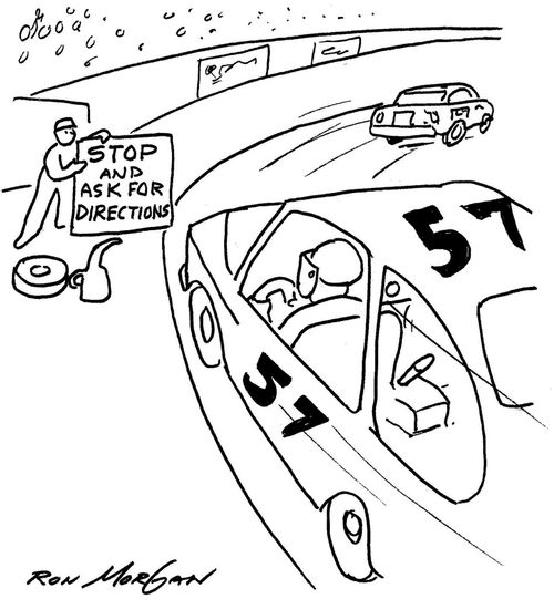 Race car driver sees Pit crew member holding sign: Stop And Ask For Directions.
