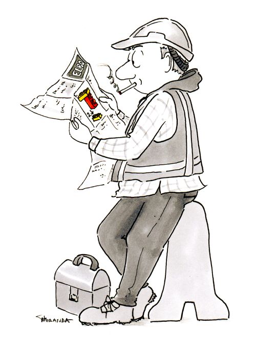 A construction worker looks at building blocks instructions.