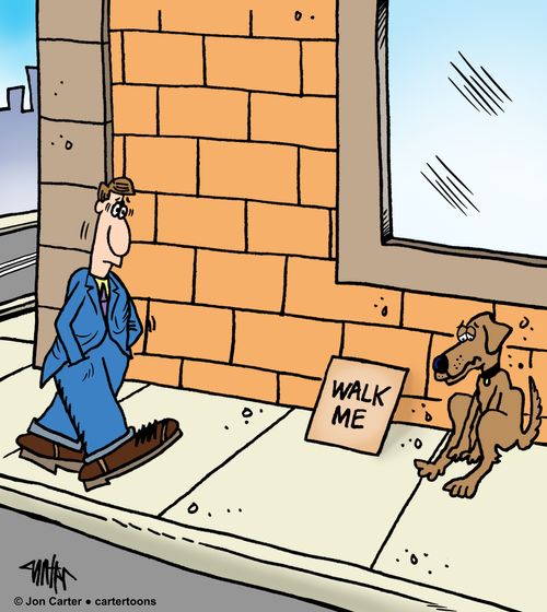 A dog on the sidewalk has a 'walk me' sign, begging for a walk.