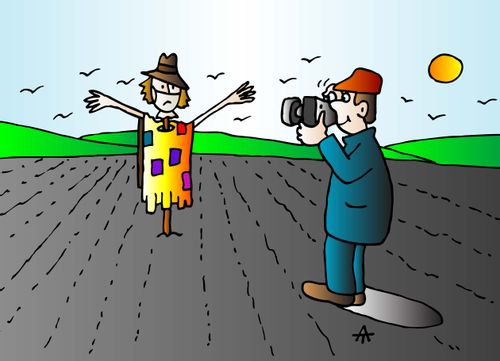 A man takes a photo of a scarecrow wearing a mask