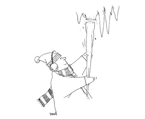 Boy breaking off a huge icicle.