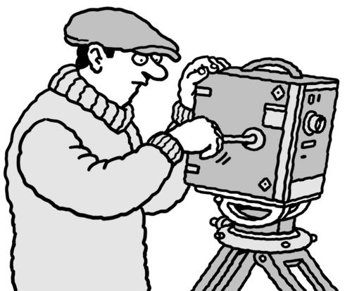 An old-fashioned camera operator cranking a movie camera