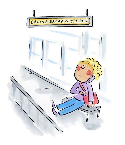 Lady waiting at Ealing Broadway station.
