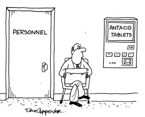 A man waiting outside a door marked Personnel