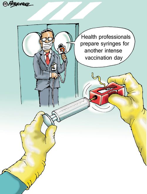 "Health professionals prepare syringes for another intense vaccination day."