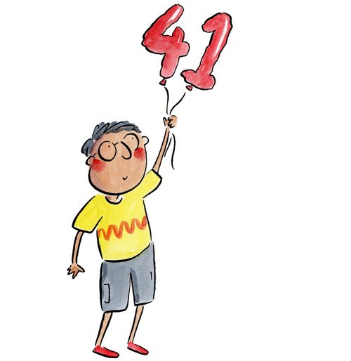 A man holding balloons shaped like '41'