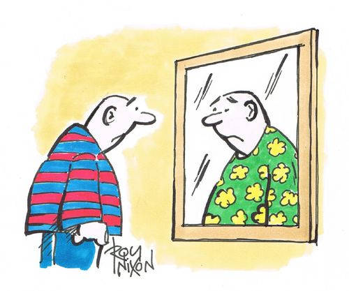 A man sadly looks at a mismatched reflection of himself