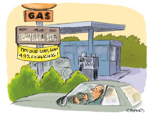 A man looks at a gas station sign that has a banner hanging from it that reads "Try our low, low 4.9% financing!".