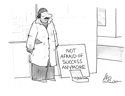 A panhandler with a sign that reads "Not afraid of success anymore".