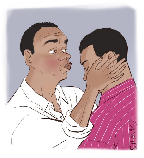 A father kisses his son on the head