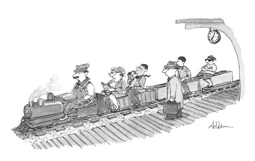 Model steam train pulls into a station