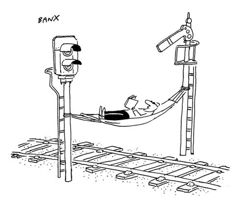 Man laying on a hammock across a railway line.